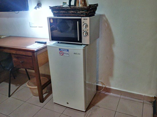 stacking of a microwave on top of a fridge